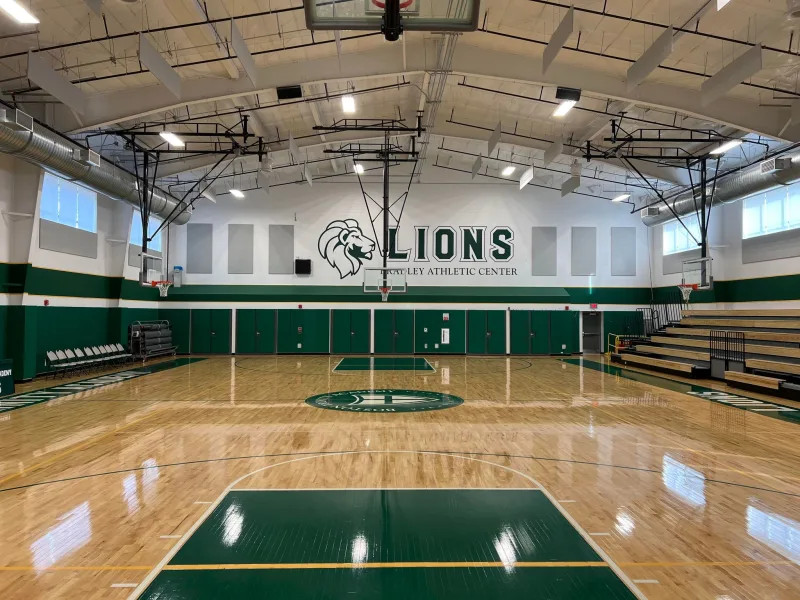 an empty gymnasium with the word lions on the opposite wall