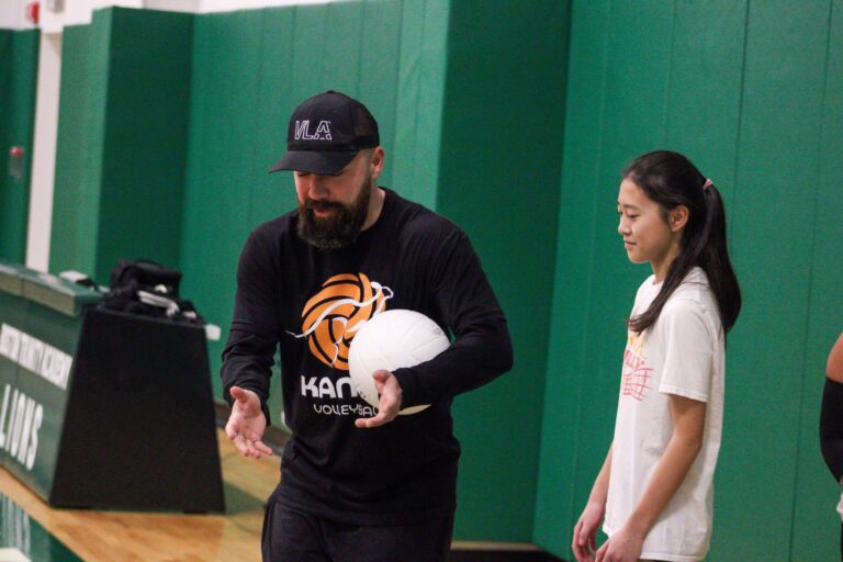 a coach and volleyball player talking
