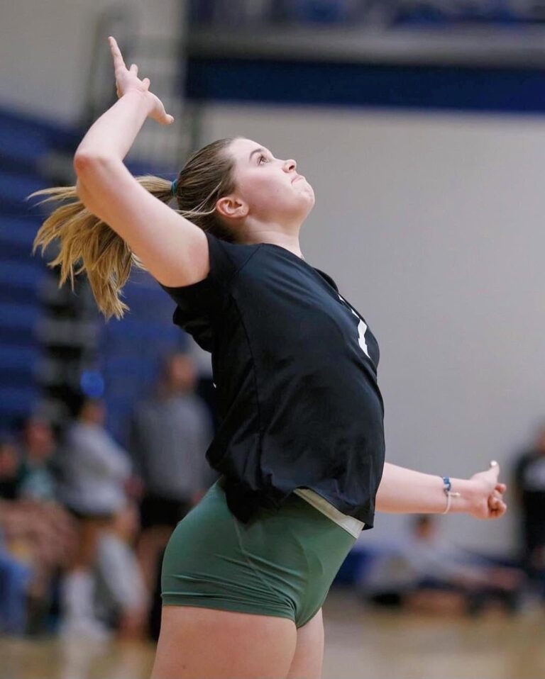 a woman hitting a volleyball