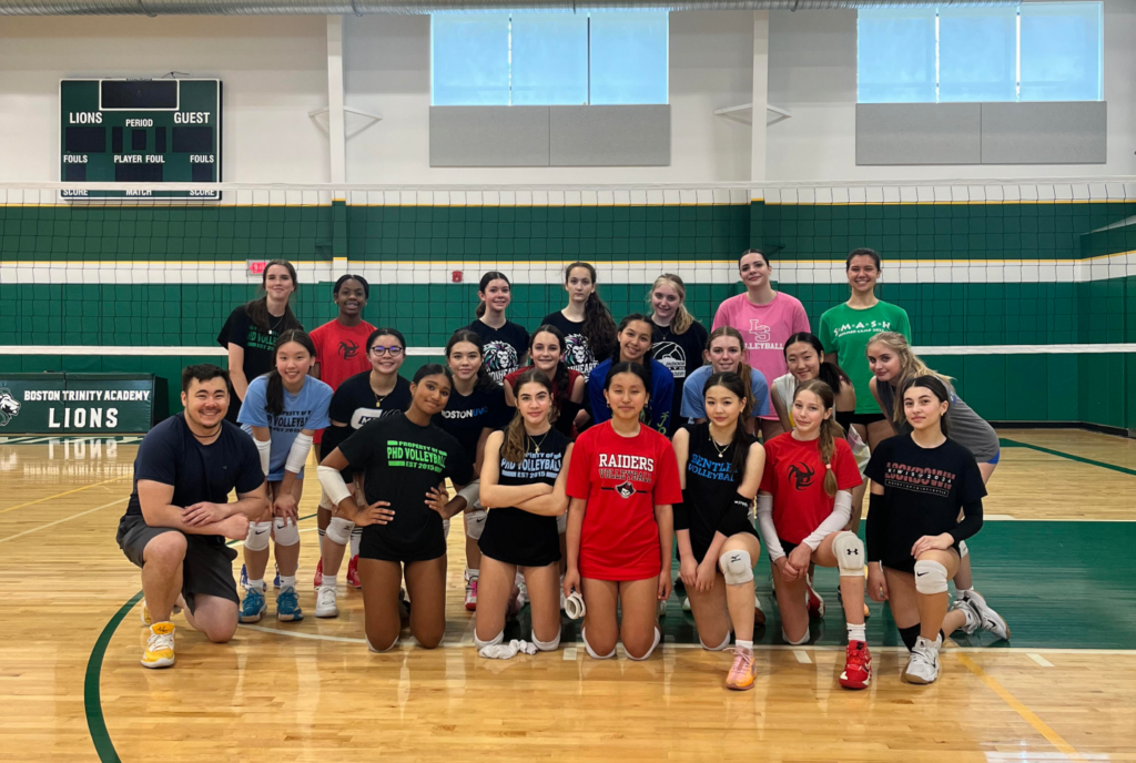 a group of volleyball players in front of a net