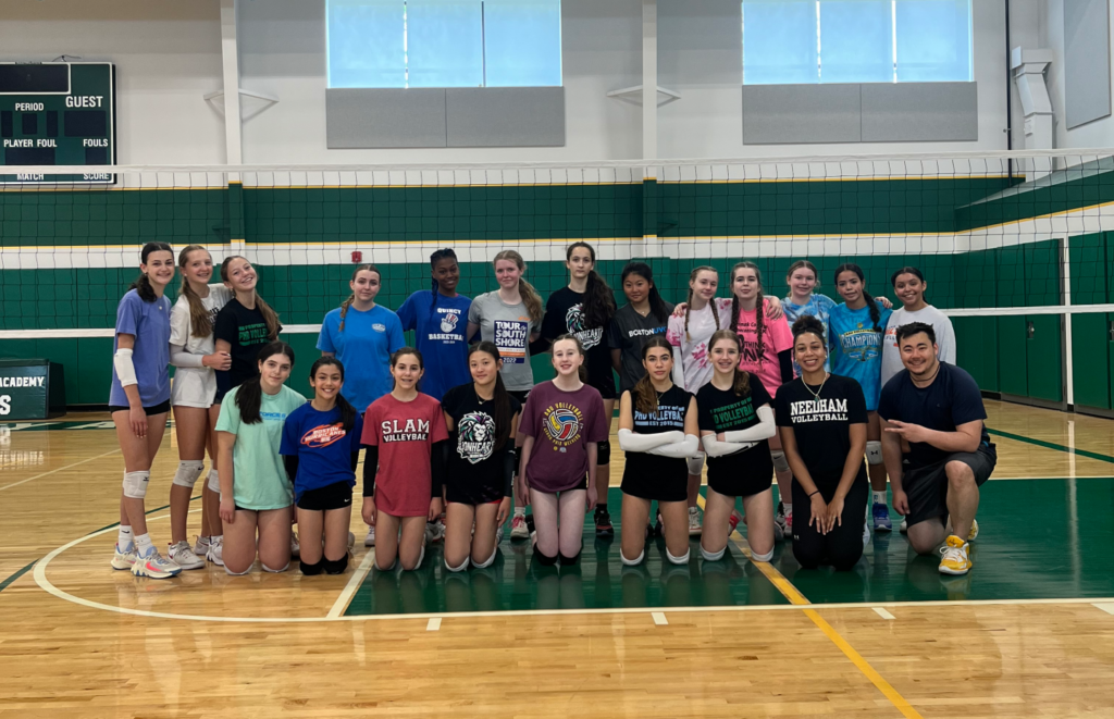 a group of volleyball players in front of a net